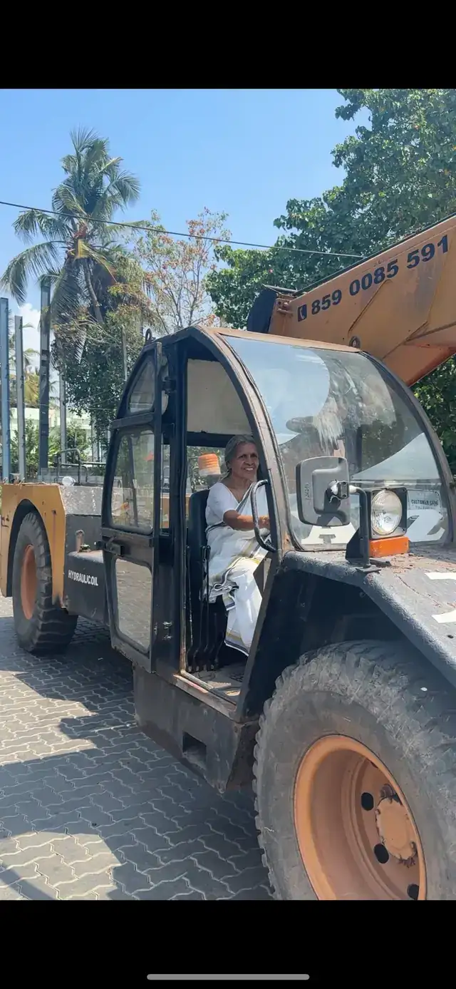 Radhamani Amma seated in the cab of an A2Z rough-terrain crane